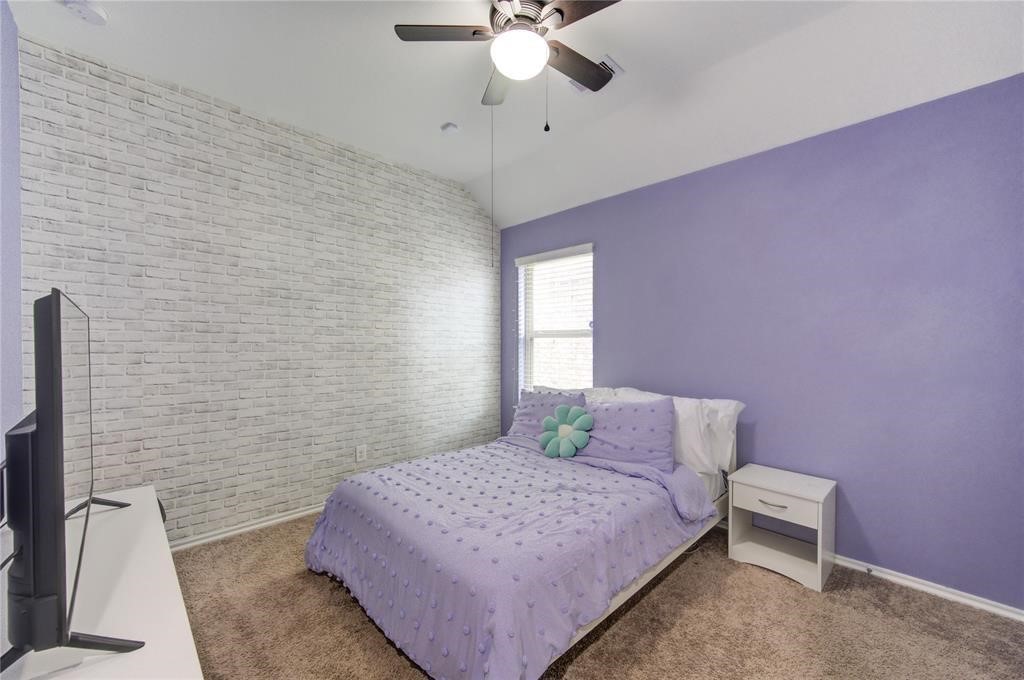 25519 Pitchfork Ranch Place Katy, TX 77493 - Photo 26 of 31 a bedroom with a bed and a chandelier