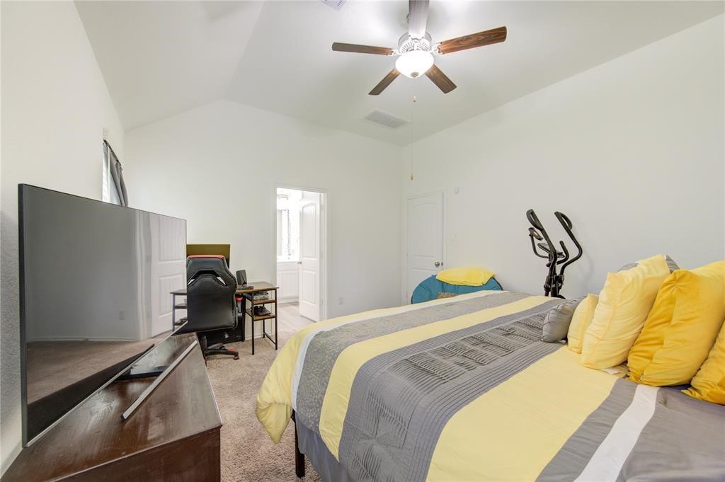 25519 Pitchfork Ranch Place Katy, TX 77493 - Photo 27 of 31 a bedroom with a bed desk and a bed