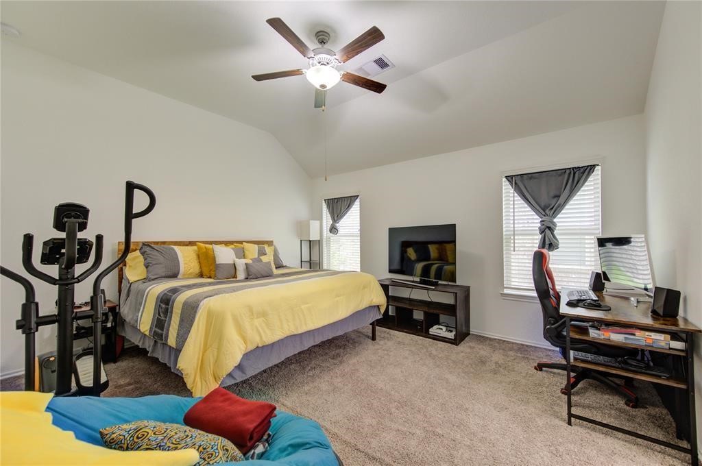 25519 Pitchfork Ranch Place Katy, TX 77493 - Photo 29 of 31 a bedroom with a bed and a chandelier