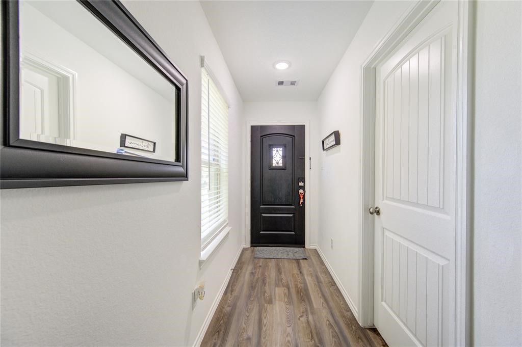 25519 Pitchfork Ranch Place Katy, TX 77493 - Photo 3 of 31 a view of a hallway with wooden floor and staircase