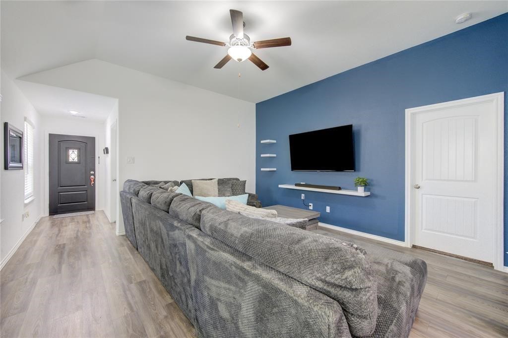 25519 Pitchfork Ranch Place Katy, TX 77493 - Photo 4 of 31 a living room with furniture and a flat screen tv