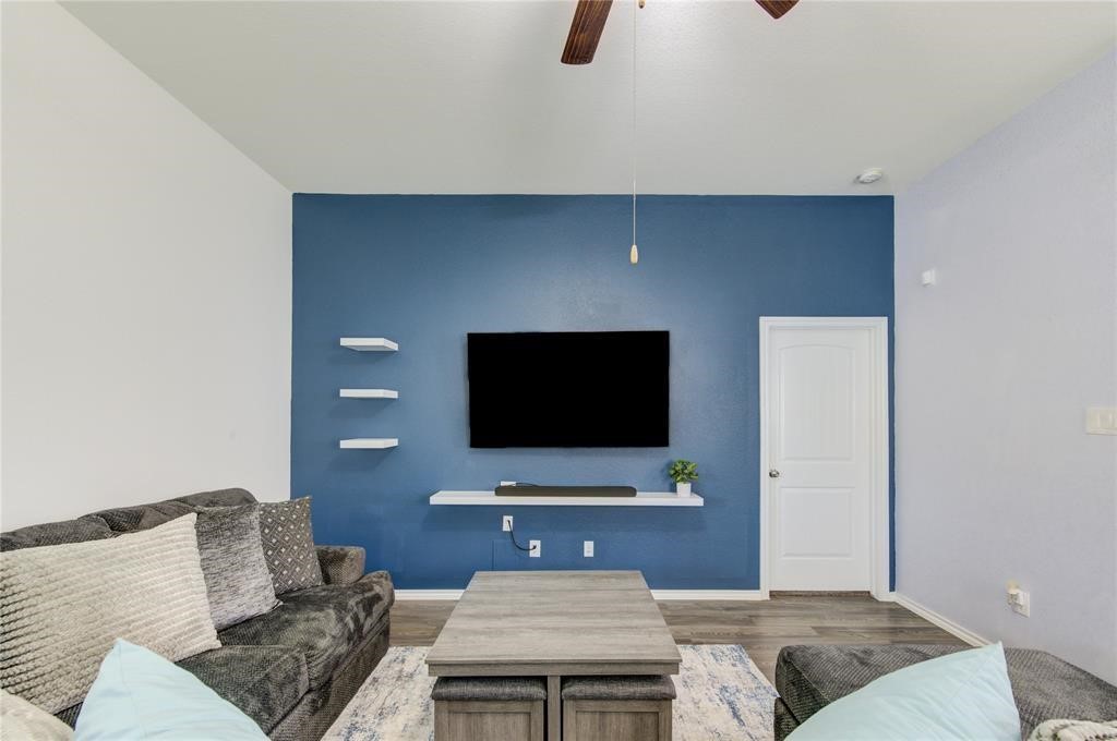 25519 Pitchfork Ranch Place Katy, TX 77493 - Photo 6 of 31 a living room with furniture and a flat screen tv