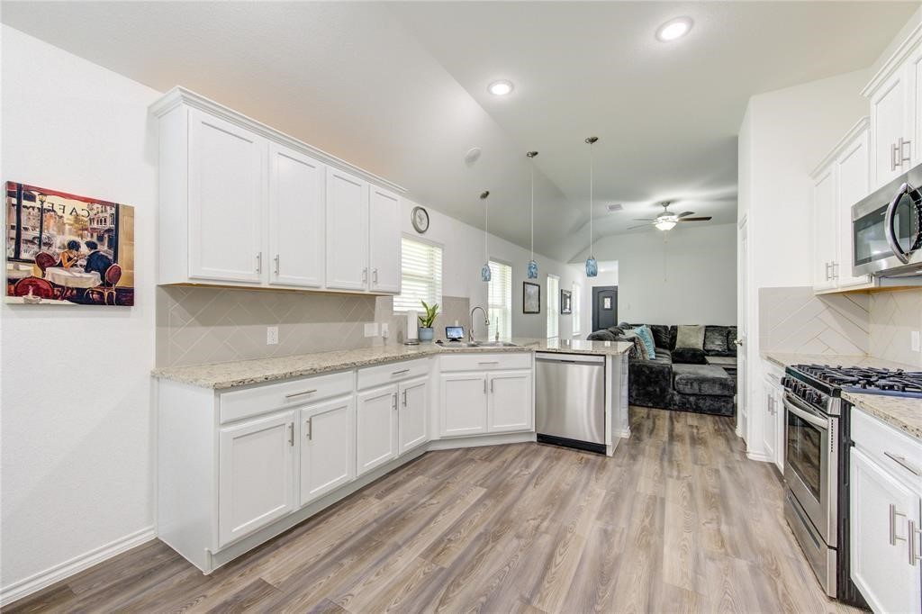 25519 Pitchfork Ranch Place Katy, TX 77493 - Photo 8 of 31 a kitchen with a sink a stove and cabinets