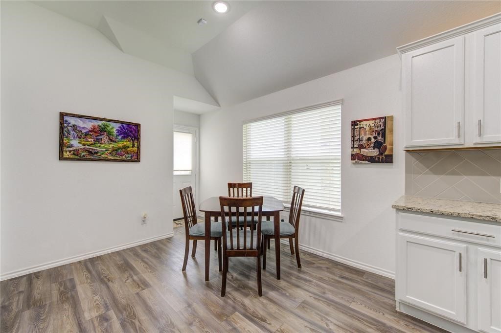 25519 Pitchfork Ranch Place Katy, TX 77493 - Photo 9 of 31 a view of a dining room with furniture and wooden floor