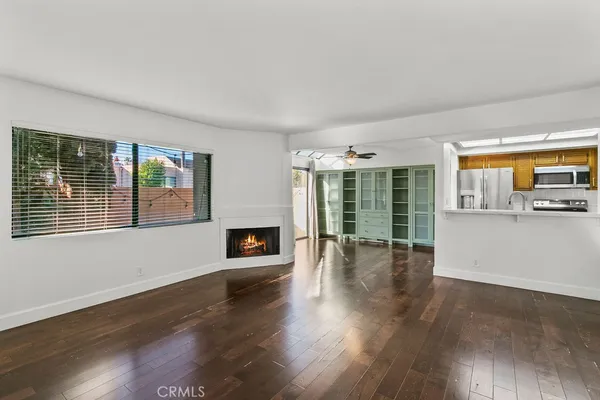 a living room with furniture a fireplace and a book shelf