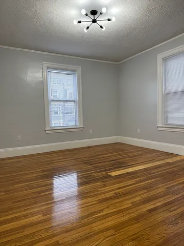 a view of a room with wooden floor and window