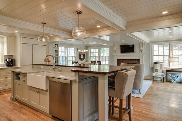 21 Fox Hill Road Wellesley, MA 02481 - Photo 3 of 30 a kitchen with stainless steel appliances granite countertop a stove top oven a sink dishwasher a dining table and chairs with wooden floor
