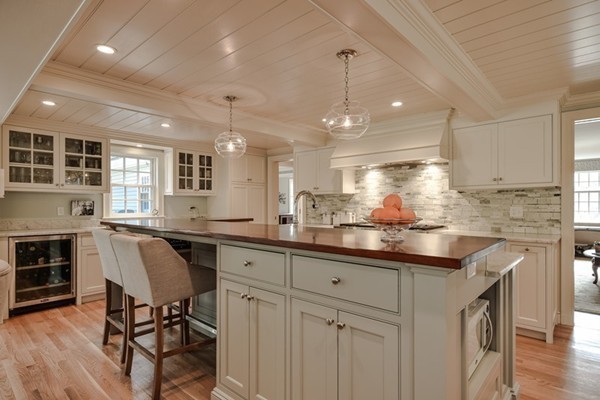 21 Fox Hill Road Wellesley, MA 02481 - Photo 9 of 30 a kitchen with granite countertop white cabinets and chairs