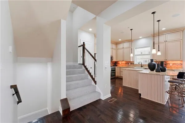 a view of kitchen with wooden floor and electronic appliances