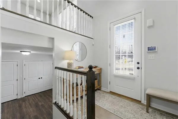 a view of a hallway with wooden floor and entryway