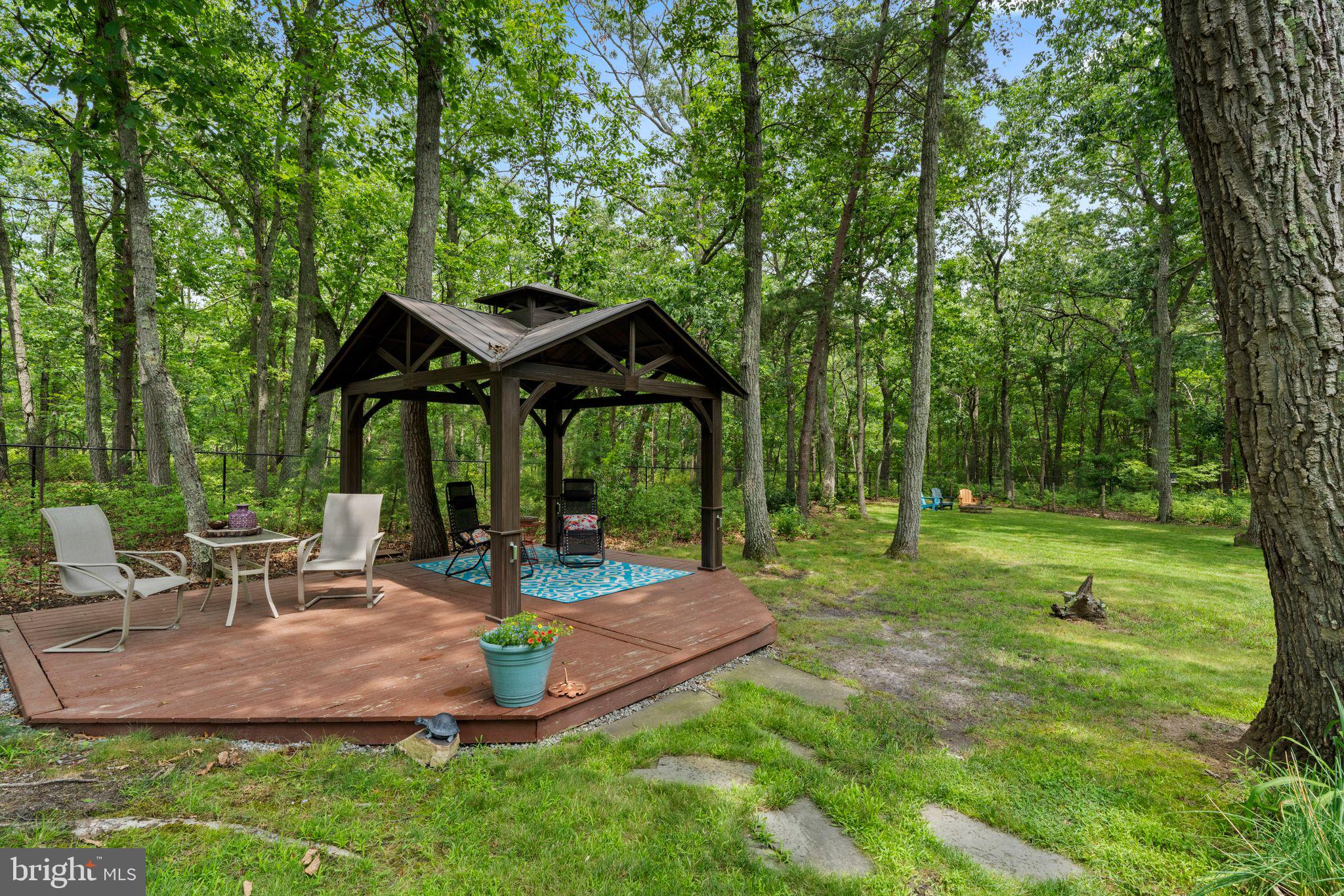 16 Dunhill Road Jackson, NJ 08527 - Photo 41 of 44 Serene gazebo nestled in lush greenery.