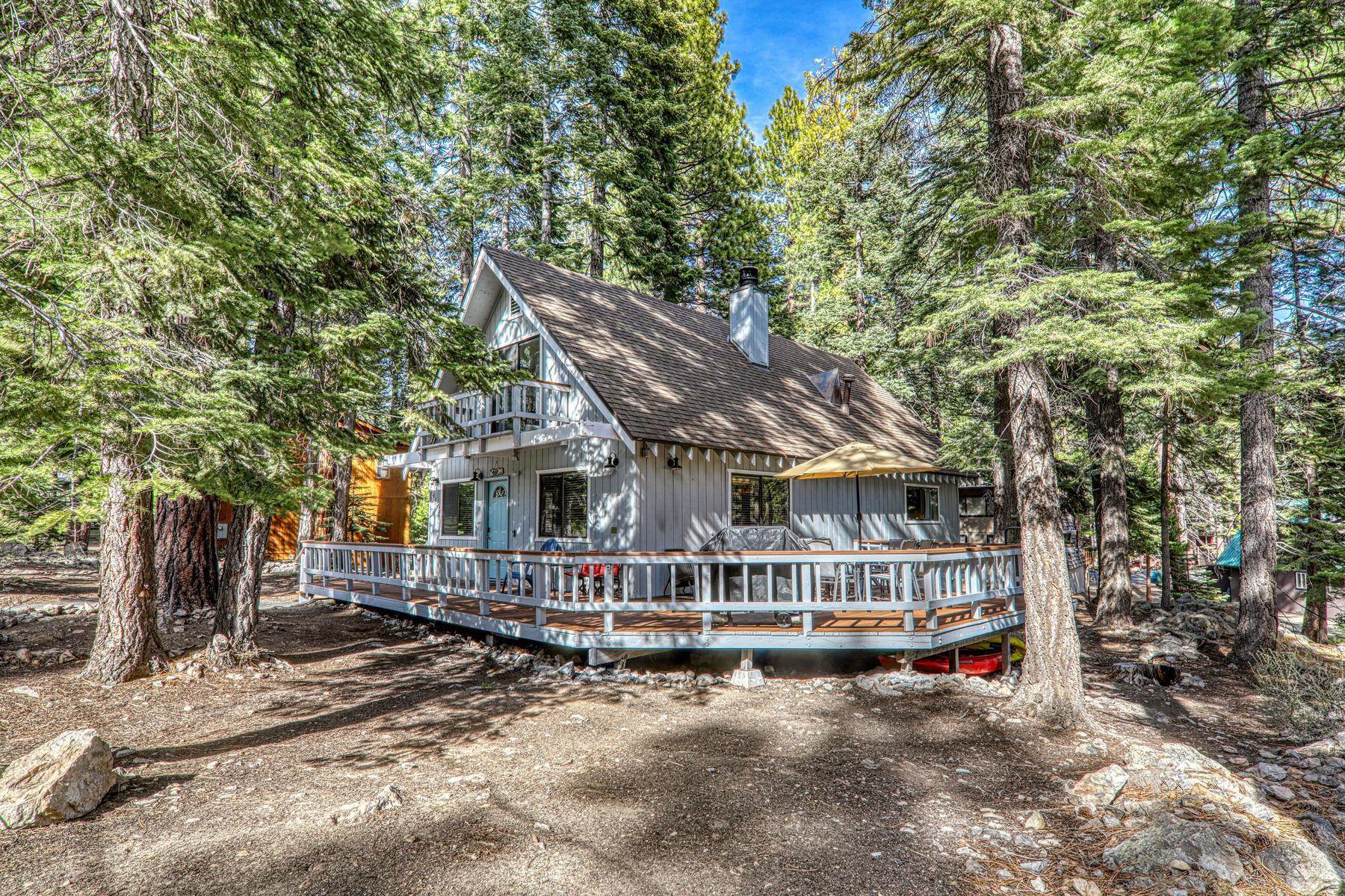 a view of house with a yard and large trees