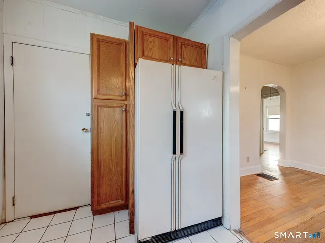 a kitchen with a refrigerator and a sink