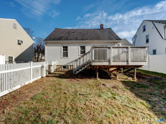 a view of a house with wooden roof and wooden fence