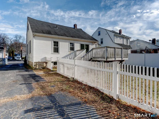 a view of a house with wooden fence
