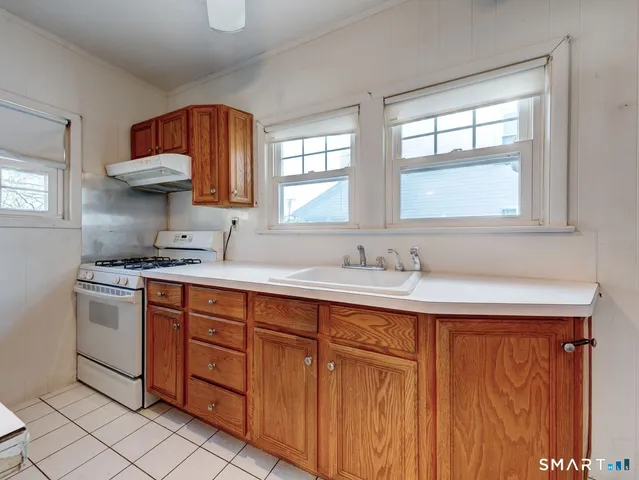 a bathroom with a refrigerator and mirror