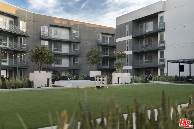 a view of a building and a yard in the background