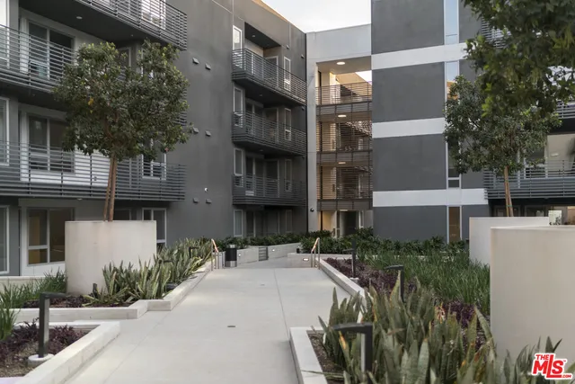 a building outdoor space with patio furniture and a fireplace