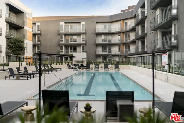 a view of a swimming pool is middle in a city