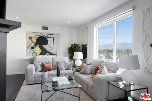 a living room with furniture and a large window