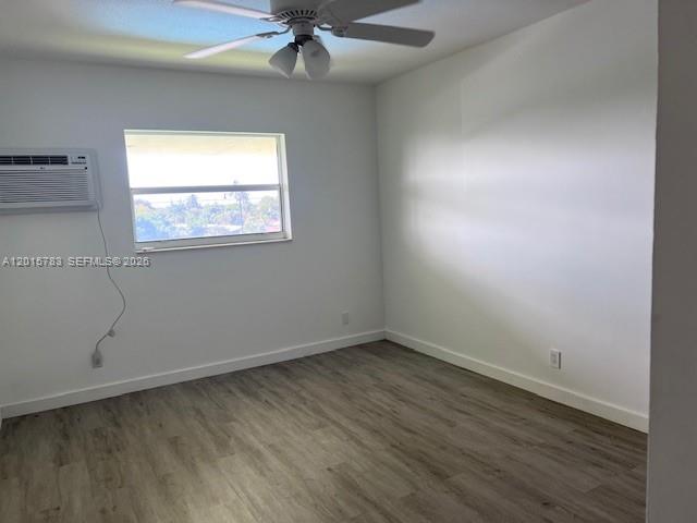 1350 East Sample Road, Unit 306 Pompano Beach, FL 33064 - Photo 11 of 13 an empty room with a window