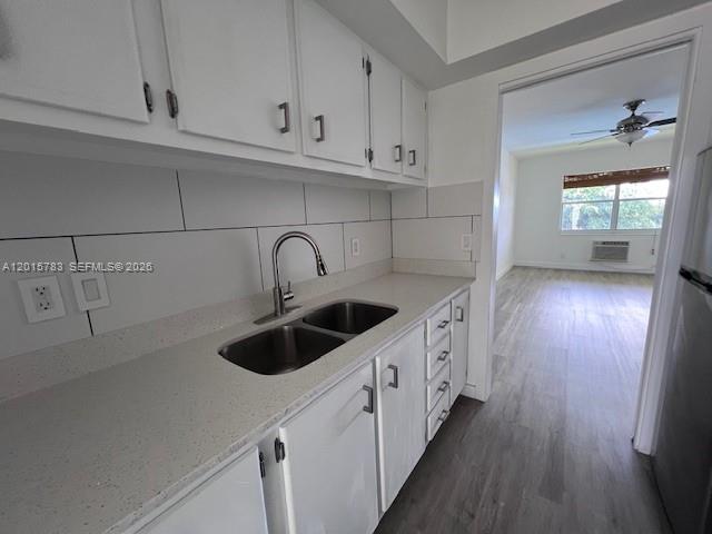 1350 East Sample Road, Unit 306 Pompano Beach, FL 33064 - Photo 2 of 13 a kitchen with stainless steel appliances granite countertop a sink and wooden cabinets