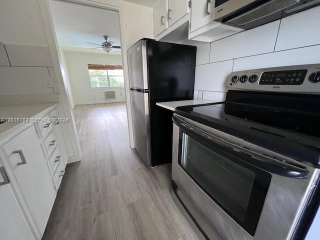 1350 East Sample Road, Unit 306 Pompano Beach, FL 33064 - Photo 3 of 13 a kitchen with wooden floors and appliances