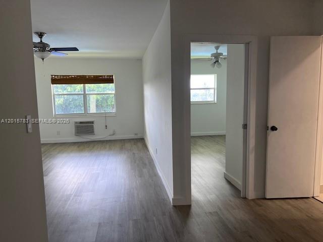 1350 East Sample Road, Unit 306 Pompano Beach, FL 33064 - Photo 4 of 13 an empty room with wooden floor and a window