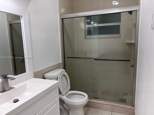1350 East Sample Road, Unit 306 Pompano Beach, FL 33064 - Photo 8 of 13 a bathroom with a sink a toilet and shower
