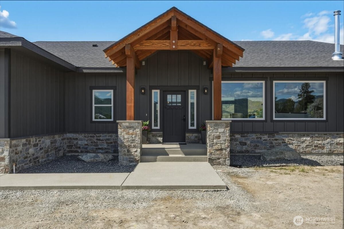 110 Slide View Lane Manson, WA 98831 - Photo 6 of 38 a front view of a house with a yard