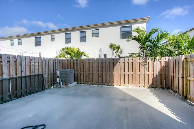 a view of a house with wooden fence