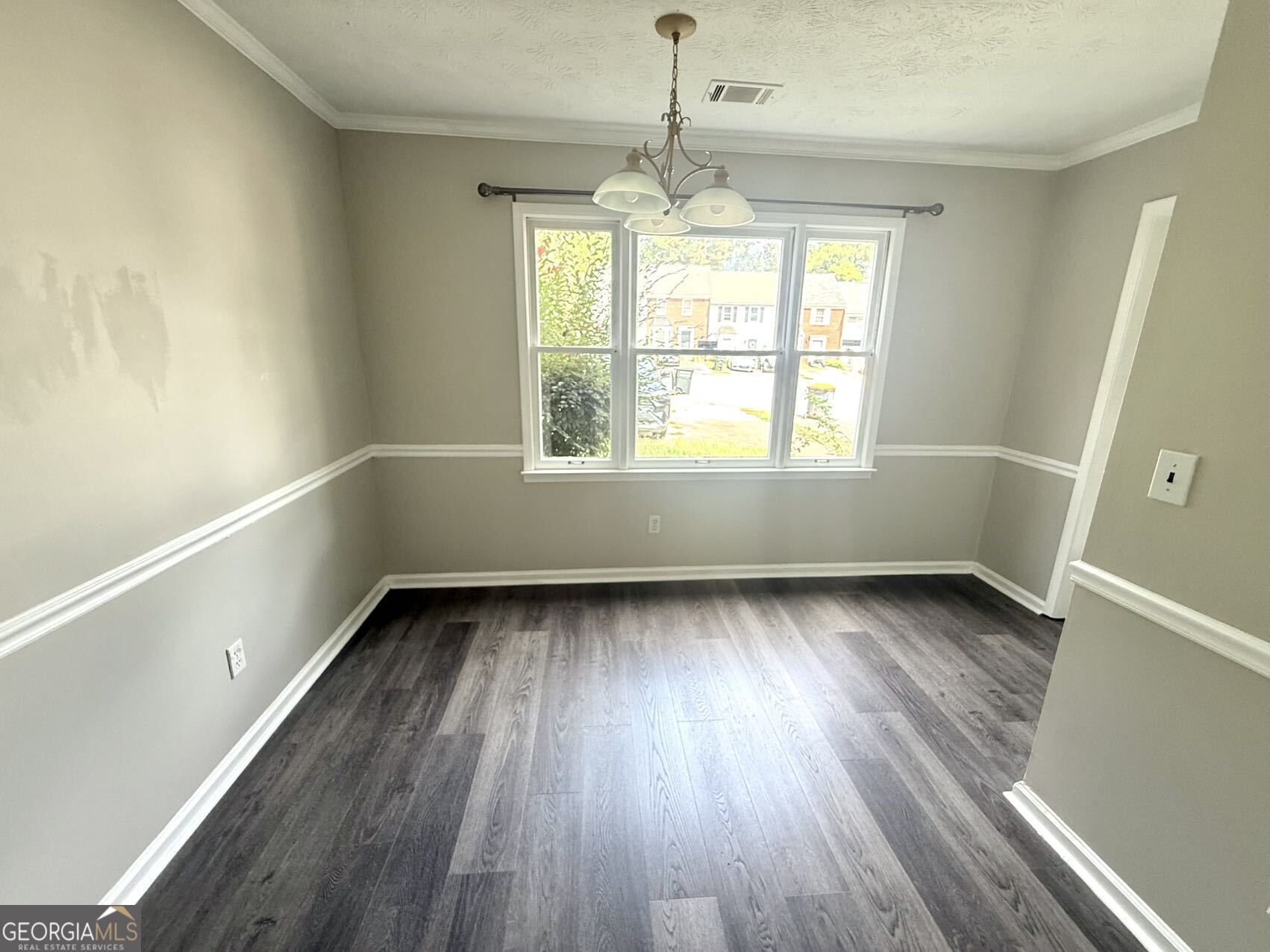 2949 Governors Court Marietta, GA 30066 - Photo 3 of 17 a view of an empty room with wooden floor and a window