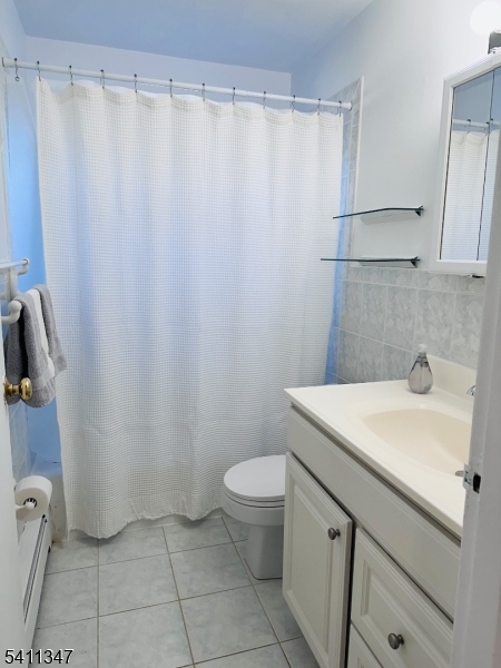 1163 Valley Road, Unit B Wayne, NJ 07470 - Photo 13 of 23 a bathroom with a sink a toilet and shower curtain
