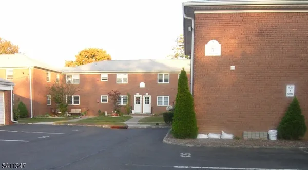 a front view of a building with parking