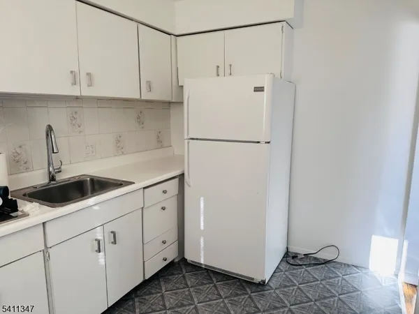 a white refrigerator freezer sitting inside of a kitchen
