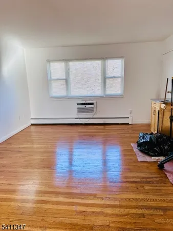 a view of a room with wooden floor and shoes