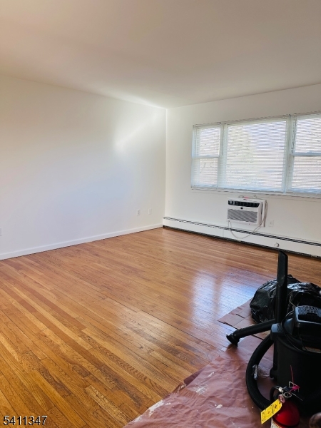 1163 Valley Road, Unit B Wayne, NJ 07470 - Photo 7 of 23 a view of a room with wooden floor and air conditioner