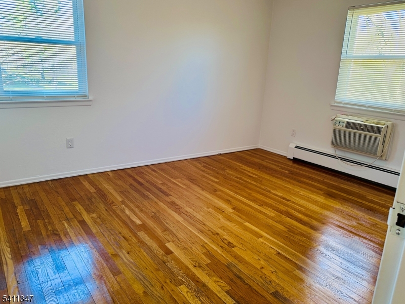 1163 Valley Road, Unit B Wayne, NJ 07470 - Photo 9 of 23 a view of a room with wooden floor and a window