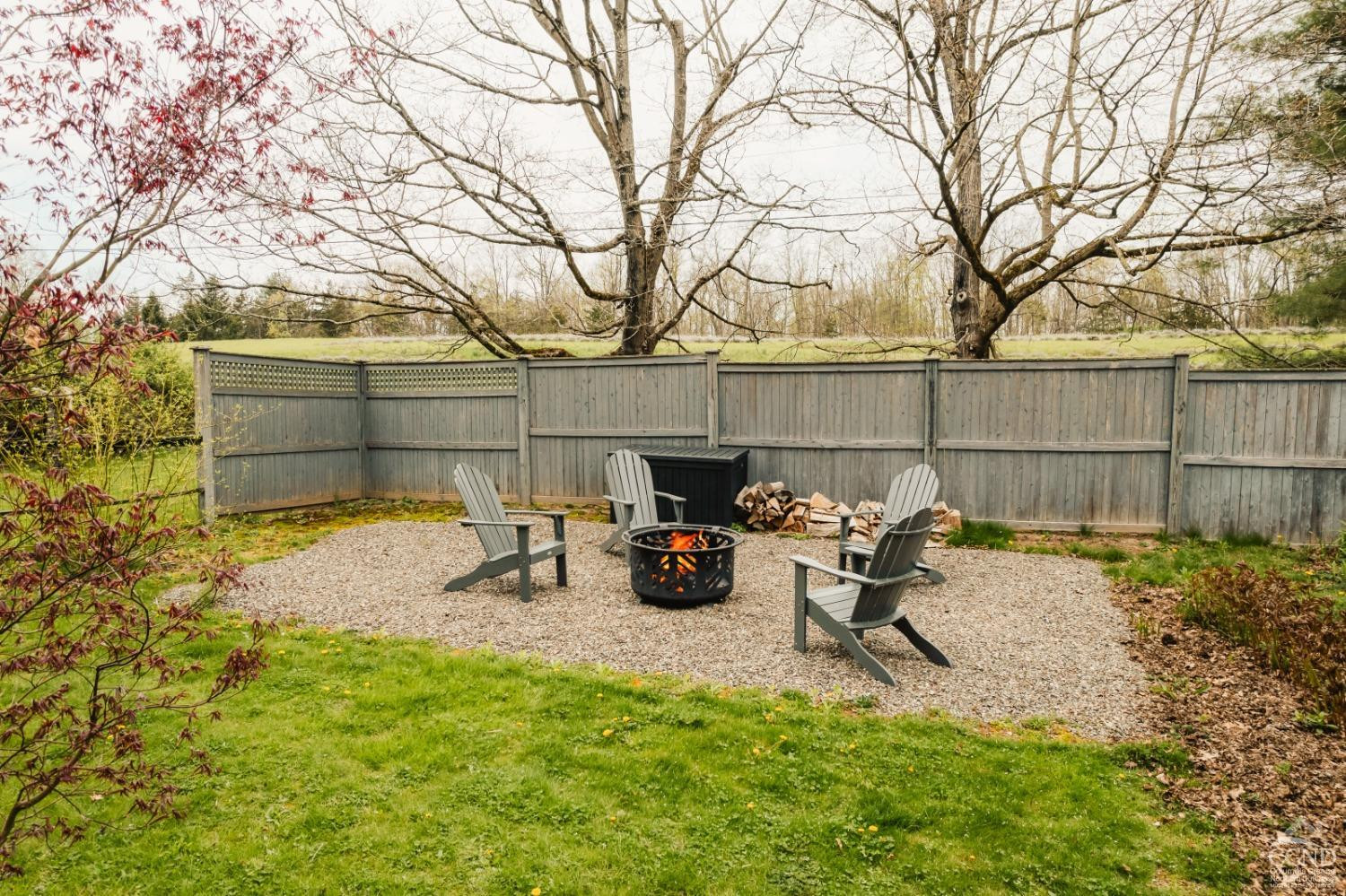 110 Stickle Road Hudson, NY 12534 - Photo 50 of 58 a view of a backyard with chairs potted plants and a large tree
