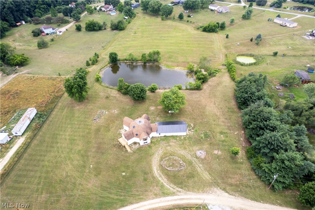 Birds eye view of property with a rural view and a water view