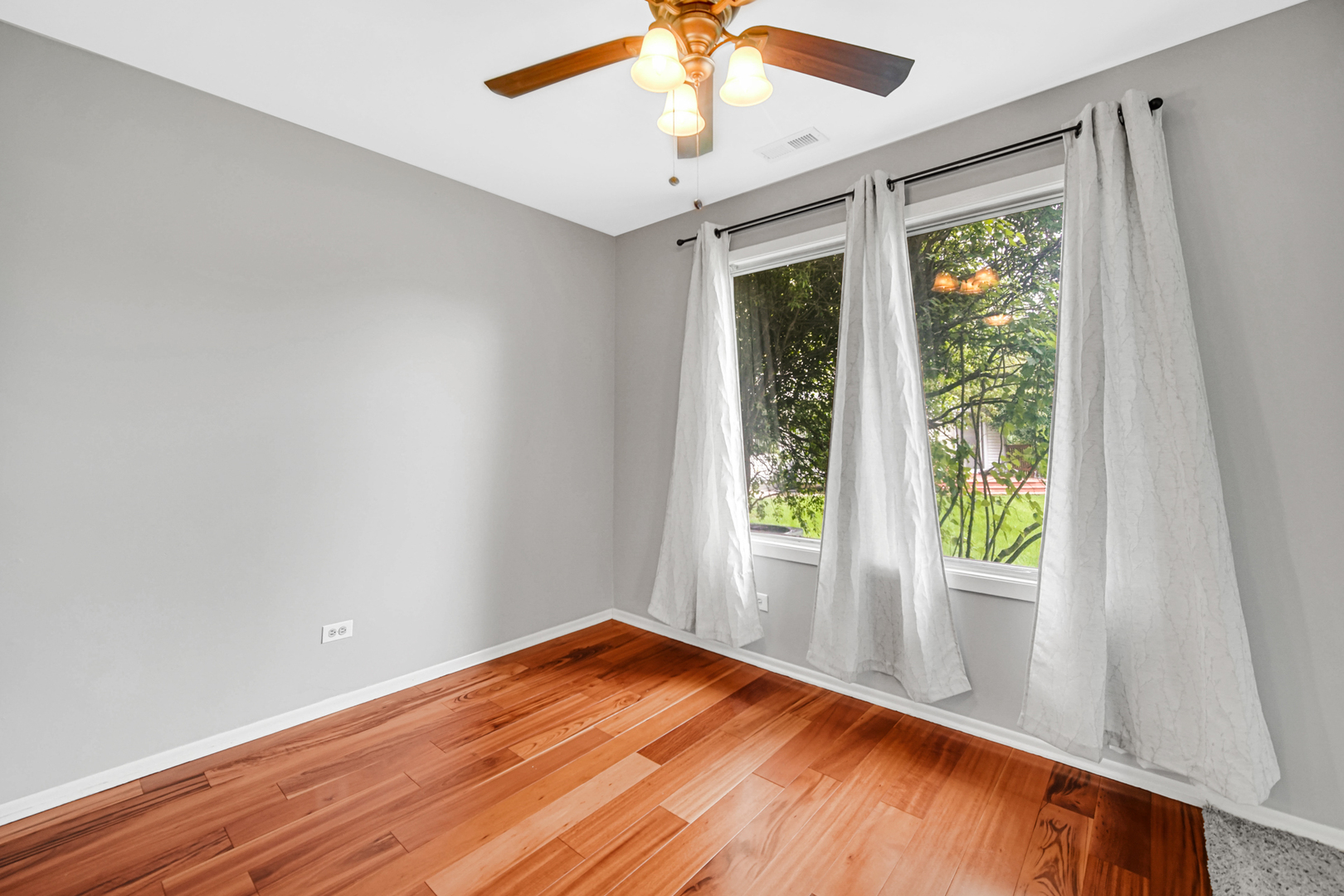 51 Churn Road Matteson, IL 60443 - Photo 13 of 20 a view of empty room with wooden floor and fan