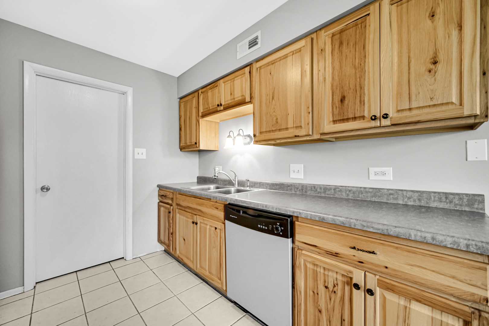 51 Churn Road Matteson, IL 60443 - Photo 15 of 20 a kitchen with stainless steel appliances granite countertop a sink and a white cabinets