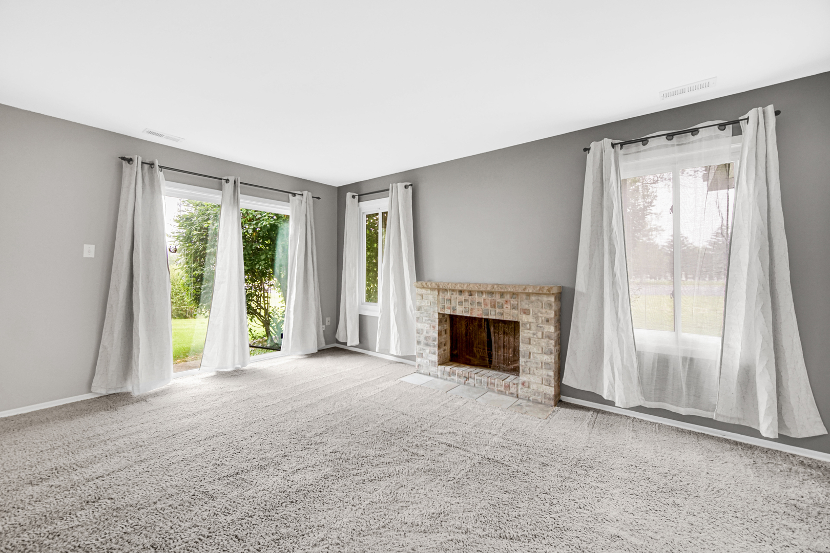 51 Churn Road Matteson, IL 60443 - Photo 10 of 20 a view of an empty room with a fireplace and a window