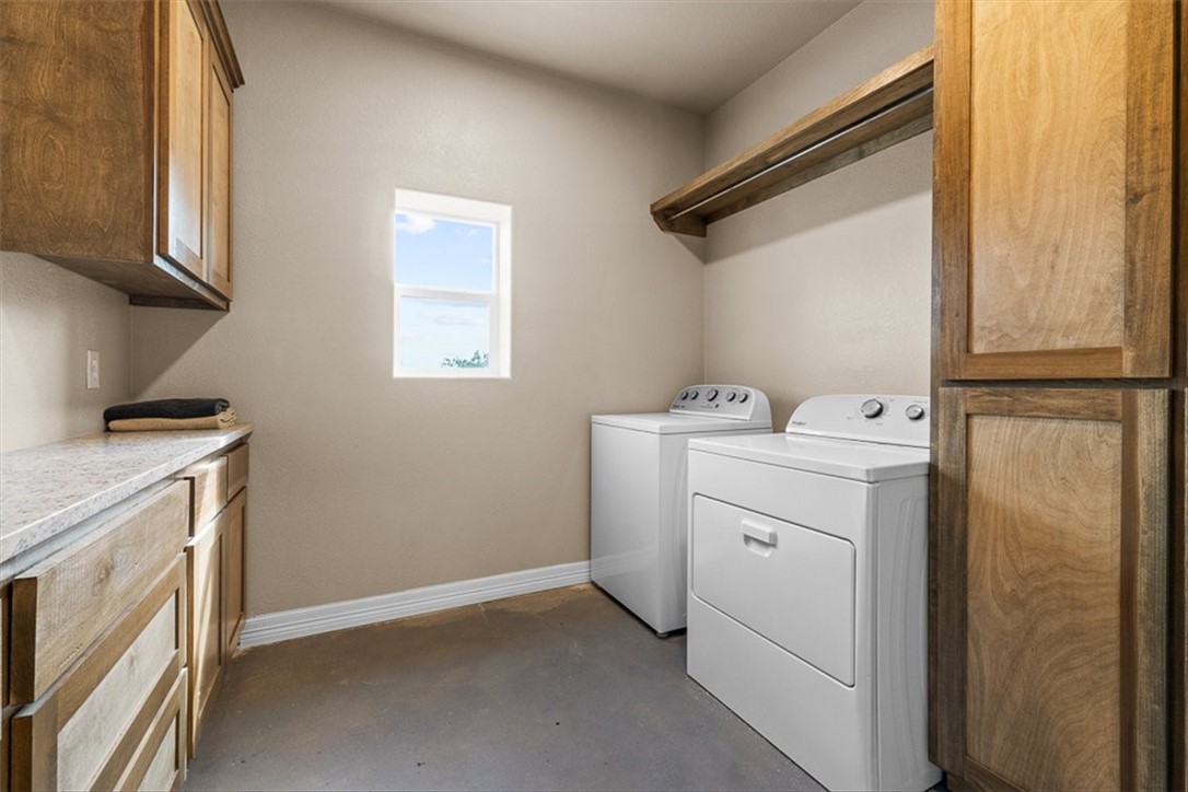 207 South Charles Street George West, TX 78022 - Photo 17 of 24 a utility room with dryer and washer