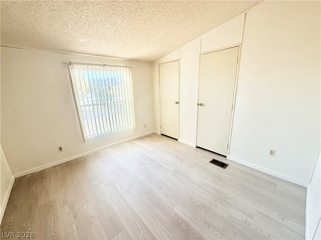 6471 Hafen Ranch Road Pahrump, NV 89061 - Photo 17 of 22 An airy bedroom featuring light-toned flooring and functional closet space offers comfortable living.