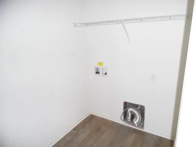 a view of a closet with wooden floor