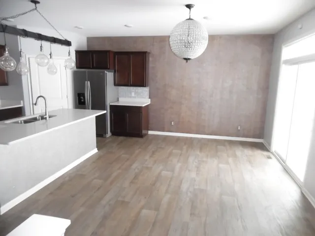 a view of a kitchen with a sink dishwasher and a refrigerator