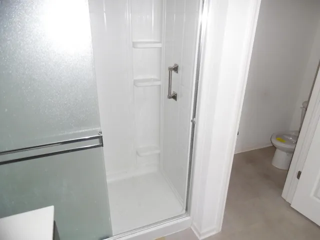 a bathroom with a glass door shower