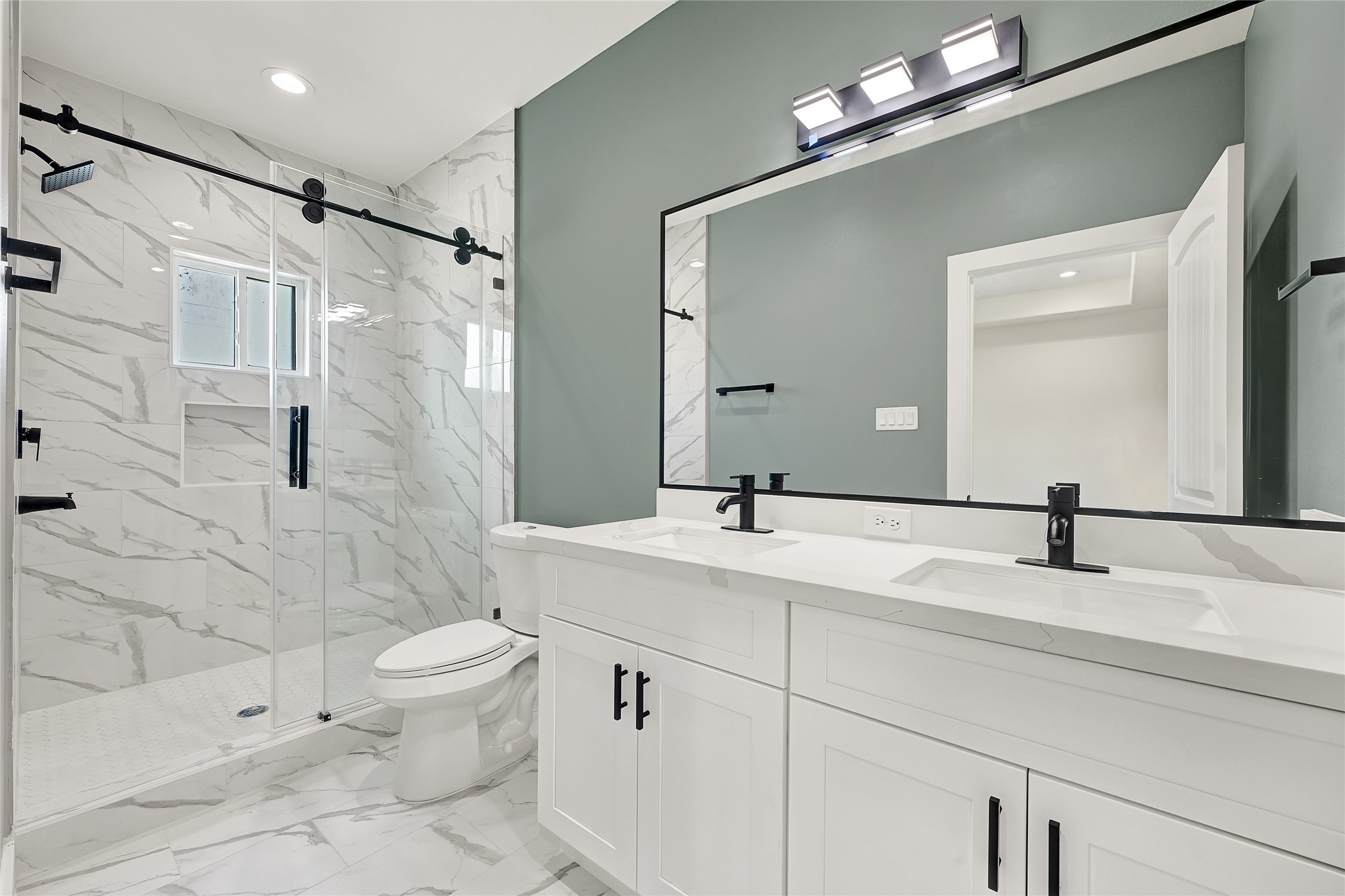 3834 Mt Pleasant Street Houston, TX 77021 - Photo 46 of 50 a bathroom with a granite countertop sink a toilet and a mirror