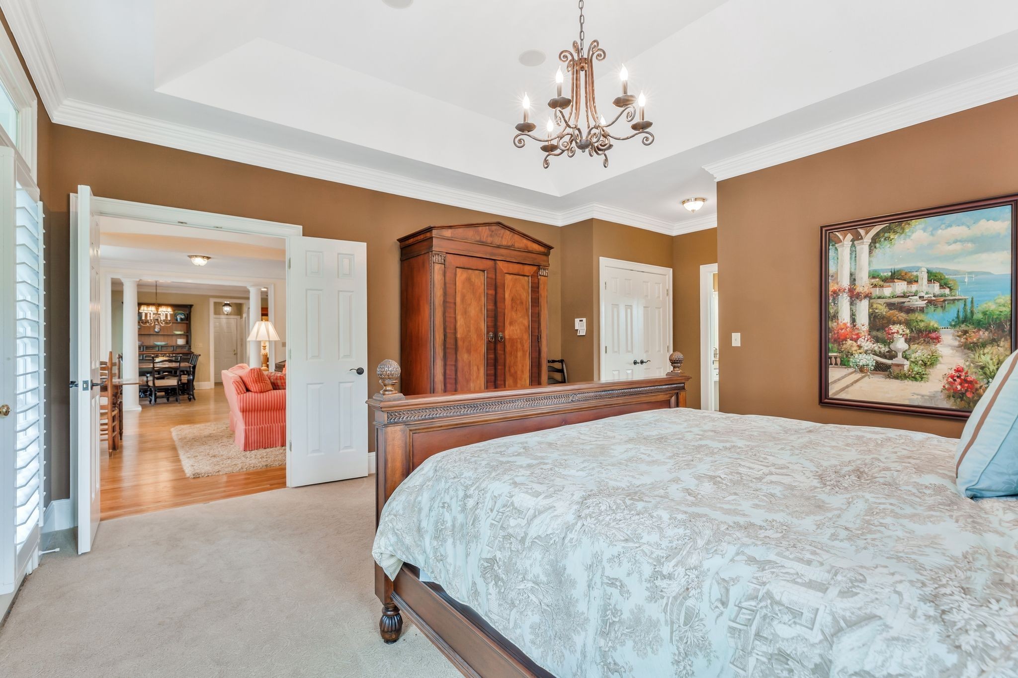 1036 Reed Hollow Road Readyville, TN 37149 - Photo 58 of 90 a spacious bedroom with a large bed and a chandelier